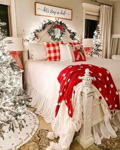 a bedroom decorated for christmas with red and white decor