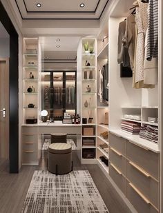 a walk in closet with lots of shelves and drawers