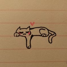 a drawing of a cat laying on top of a piece of lined paper with a heart