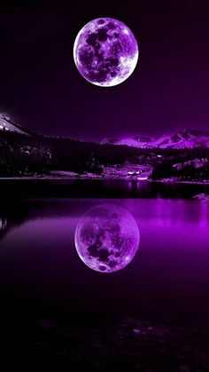 the full moon is shining bright purple in the night sky over a lake and mountain range