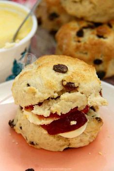 a scone with jam and cream on it