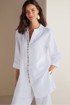 Decorative multi-colored buttons add a playful pop to this otherwise polished linen design. This longer length tunic features classic, clean lines courtesy of a mandarin collar and side slits at the hem. Delicate tonal soutache trim completes the look. Full zip front. Petite Womens Clothing, Linen Design, Stylish Tunic, Gauze Shirt, Velvet Tunic, White Linen Pants, White Tunic, Linen Tunic, Caftan Dress