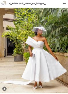 a woman wearing a white dress and veil