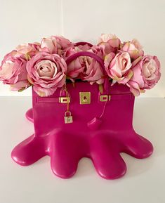 a pink handbag with flowers in it