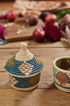 two baskets sitting on top of a wooden table