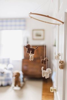 a toy dog hanging from the side of a door in a room with white walls