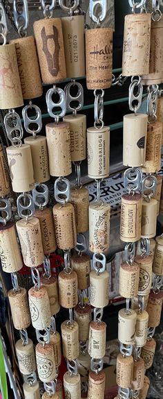 several wine corks are hanging on a rack