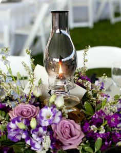 Wedding Channel - centerpiece made with yam roses, purple eustomas and fillers Oil Lamp Centerpiece, Wolf Wedding, Purple Centerpiece, Lanterns With Flowers, Purple Centerpieces, Wedding Centrepiece, Roses Purple, Candle Luminaries, Storybook Wedding