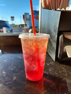 a red drink sitting on top of a table