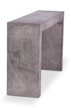 a concrete bench sitting on top of a white floor