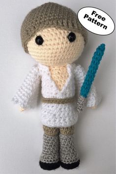 a crocheted star wars doll holding a blue object