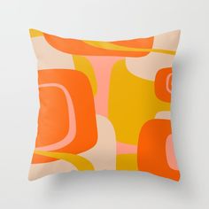 an orange and yellow pillow on a white wall