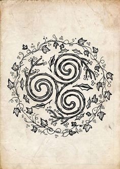 an old book with swirls and leaves in the middle, on top of a white paper