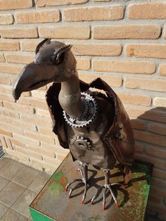 a sculpture of a bird wearing a leather jacket