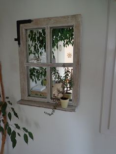 a potted plant sitting on top of a window sill next to a white wall