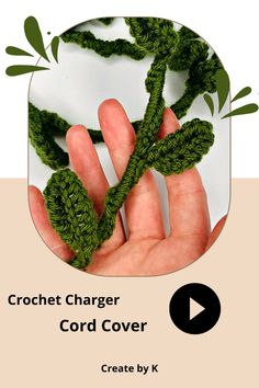 the crochet charger cord cover is made from green yarn and has leaves on it