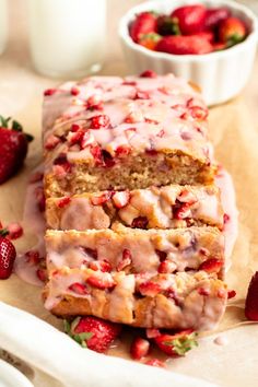 sliced loaf of strawberry bread with icing and strawberries