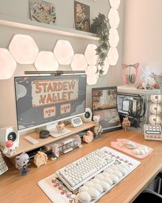 there is a computer on the desk with many other items around it, including a keyboard and mouse