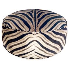 a zebra print bean bag sitting on top of a white floor