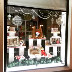 a window display with christmas decorations and teddy bears in it's windowsills