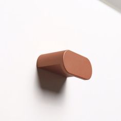 a close up of a brown object on a white surface