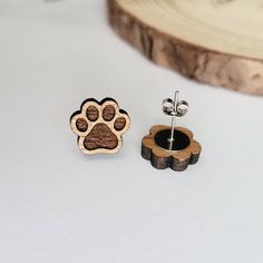 These beautiful wooden dog paw print stud earrings are meant for every dog lover and animal person alike. Best of all, they are also hypoallergenic, lightweight, and great for everyday wear! Each pair of earrings is laser cut in-house using sustainable American hardwood and sealed with a hypoallergenic shellac topcoat. Earrings are finished with hypoallergenic stainless steel posts. Material: sustainable American hardwood Sizing: 0.6 inch L x 0.5 inch W Laser Dog Ideas, Wood Laser Earrings, Wooden Earrings Laser Cut, Laser Bracelet, Laser Engraving Ideas, Wooden Earrings Studs, Laser Earrings, Laser Jewelry, Laser Engraved Earrings