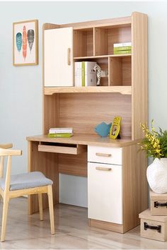 a desk and chair in a room with blue walls, wood flooring and white furniture