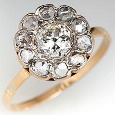 an antique diamond cluster ring in yellow gold