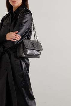 SAINT LAURENT's 'Niki Baby' bag is purposefully crinkled and crackled to look like a vintage find. Made in Italy from glossed-leather, it has a sliding chain strap, so you can alter the drop and is topped with a tonal logo plaque. Despite its mini size, the compartmented interior will easily hold your cell phone, cardholder and compact. Ysl Niki Bag Outfit, Ysl Niki Bag, Chain Bag Outfit, Mini Bag Outfit, Ysl Outfit, Shoulder Bag Outfit, Luxury Purses, Mini Quilt, Saint Laurent Bag