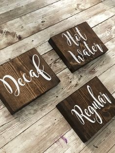 three wooden signs with the words decal water and pequn written on them