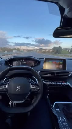 the interior of a car with dashboard, steering wheel and touch screen display on it