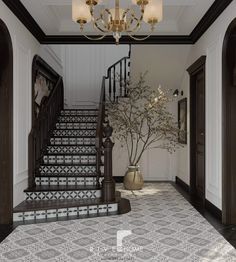 a foyer with stairs and chandelier next to a potted plant on the floor