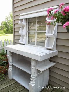 an old window is painted white and has flowers in the potted planter outside