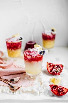 the pomegranate is garnished with fresh fruit and served in glasses