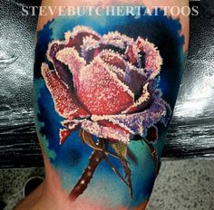 a tattoo with a pink rose on it's leg and the words steubucherttatos