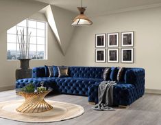 a living room with blue couches and pictures on the wall