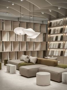 a living room filled with lots of furniture and bookshelves on the wall next to each other