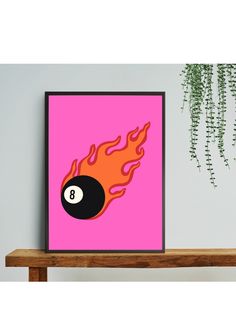 a pink poster with a billiard ball on it and flames coming out of it