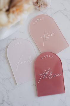 three pink and white tags on a marble surface with the word bride to be written in cursive writing