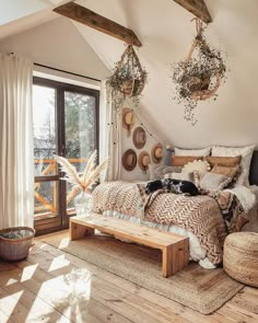 a bed room with a wooden floor and lots of pillows