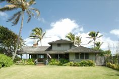 a house with palm trees in the background