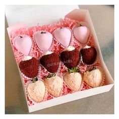 a box filled with lots of different types of chocolate covered strawberries on top of each other