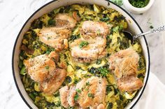 chicken and spinach casserole in a pan with a spoon