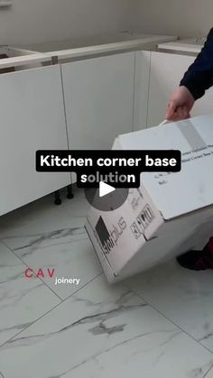 a man is opening a box in the kitchen