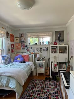 a bed room with a neatly made bed and a piano