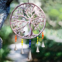 a wind chime hanging from a tree with colorful beads