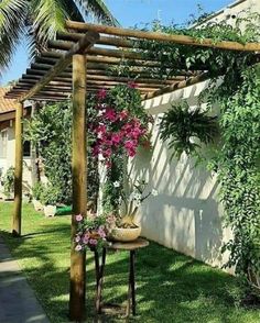 an outdoor area with flowers and plants on the grass