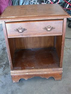 an old wooden table with two drawers