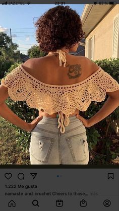 the back of a woman's top that is crocheted