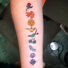 a person with a tattoo on their arm that has different things in the shape of letters